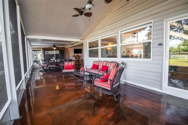 sunroom with outdoor dining area, ceiling fan, lofted ceiling, and wooden walls