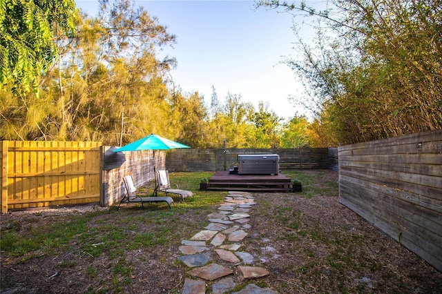 view of yard featuring a fenced backyard and a hot tub