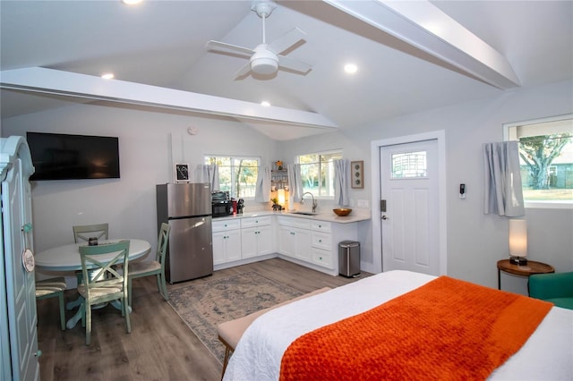 bedroom with freestanding refrigerator, multiple windows, a sink, and dark wood-type flooring