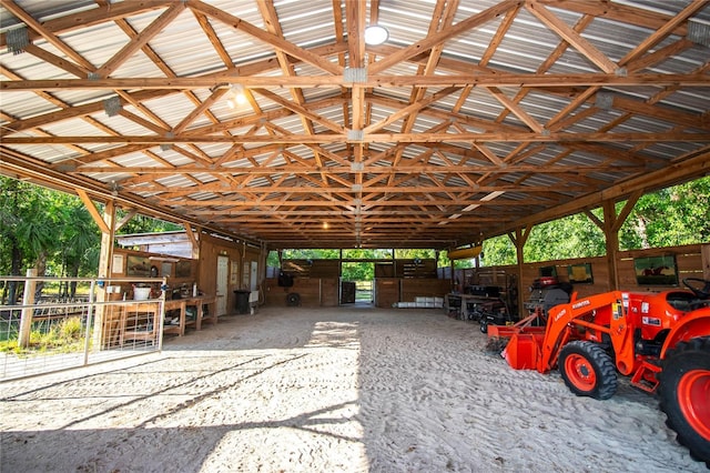 view of parking / parking lot featuring an exterior structure and a carport