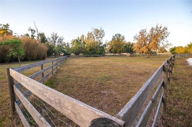 view of yard featuring fence and a rural view