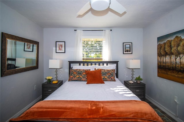 bedroom featuring baseboards, ceiling fan, and wood finished floors
