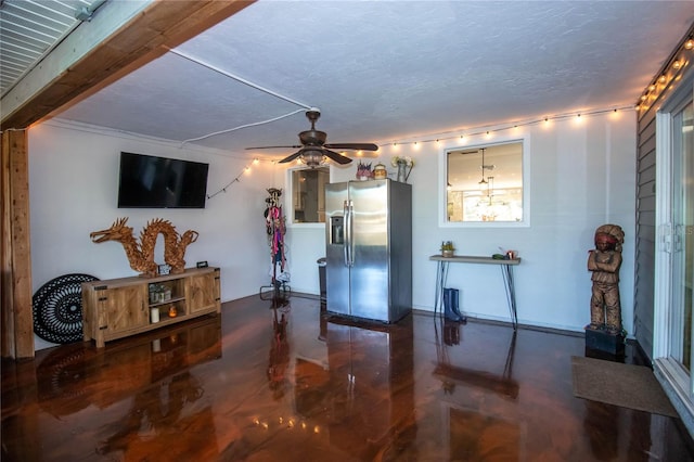 living room with a textured ceiling, concrete flooring, and ceiling fan