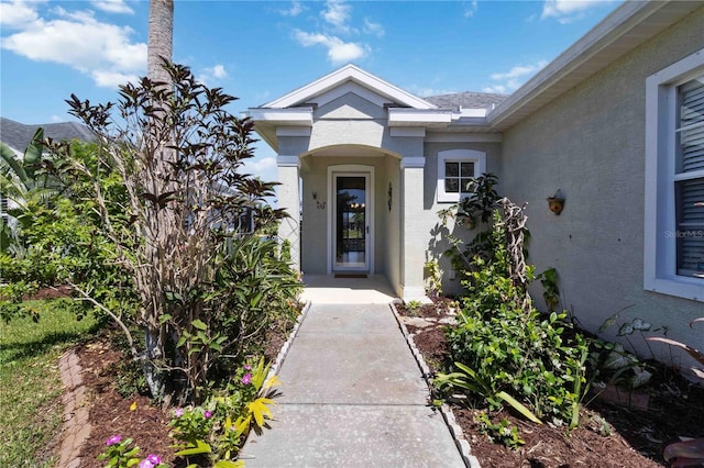entrance to property featuring stucco siding
