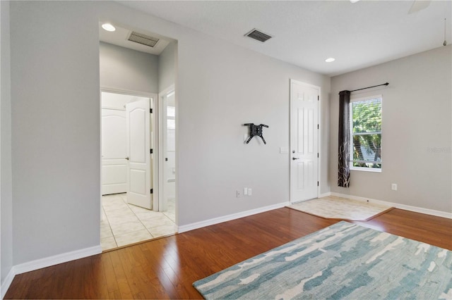 entryway featuring baseboards, visible vents, and hardwood / wood-style flooring
