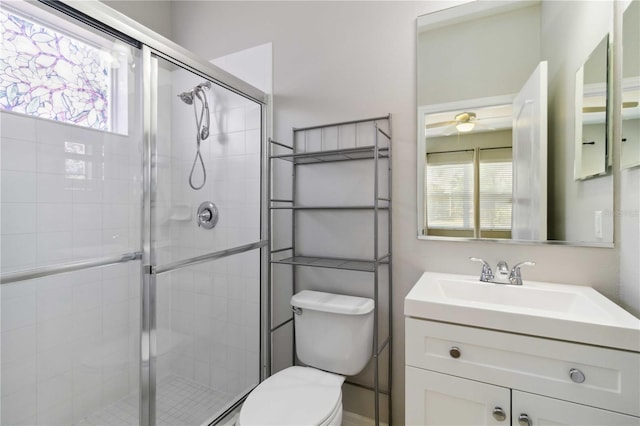 bathroom with a stall shower, a healthy amount of sunlight, and toilet
