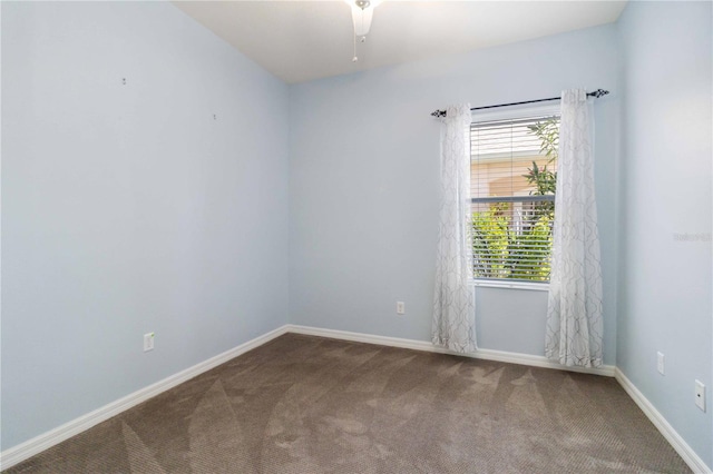 spare room featuring carpet floors, baseboards, and a ceiling fan