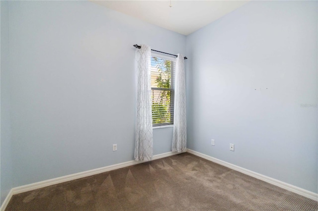 empty room with baseboards and carpet flooring