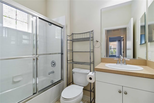 full bathroom featuring vanity, combined bath / shower with glass door, toilet, and visible vents