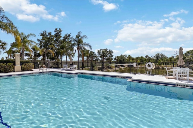 pool featuring fence and a patio area