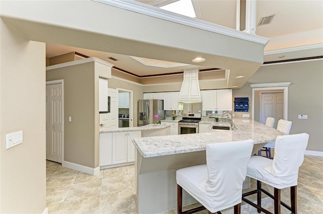 kitchen with crown molding, a peninsula, custom exhaust hood, a sink, and appliances with stainless steel finishes