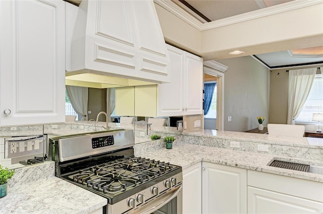 kitchen featuring crown molding, white cabinetry, gas stove, and custom range hood