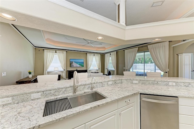 kitchen with visible vents, crown molding, dishwasher, a sink, and a raised ceiling