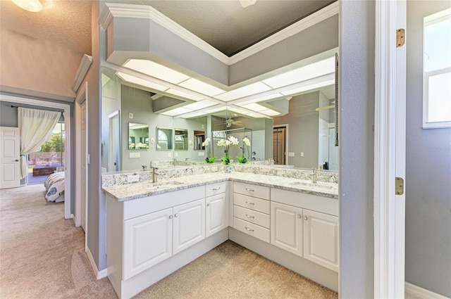 bathroom with a sink, crown molding, ensuite bath, and double vanity