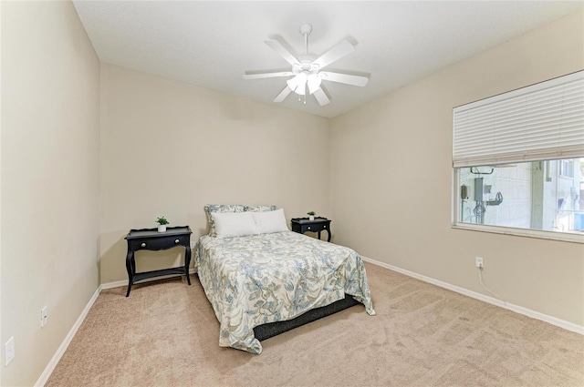 bedroom with baseboards, light carpet, and a ceiling fan