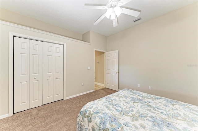 bedroom with ceiling fan, carpet, baseboards, visible vents, and a closet
