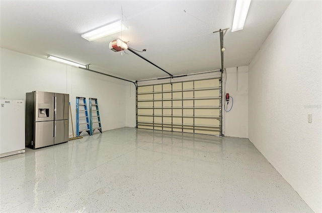 garage featuring stainless steel fridge and fridge