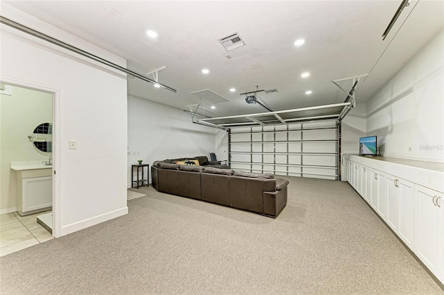 garage featuring baseboards, recessed lighting, and visible vents