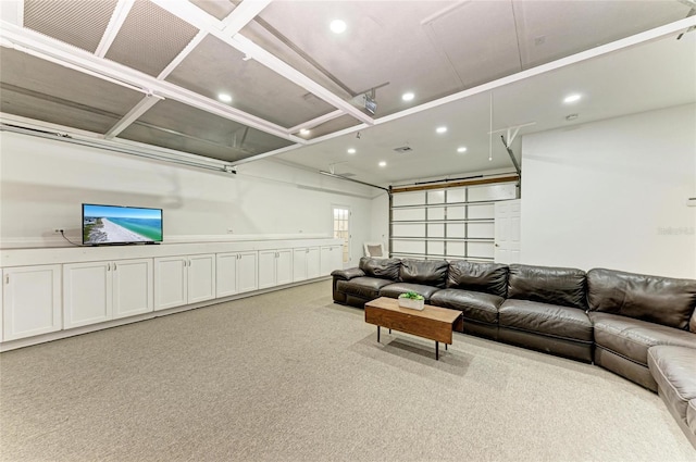 living area featuring carpet, recessed lighting, and a garage