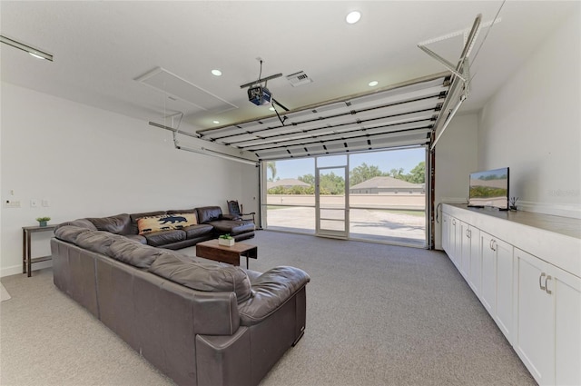 living area featuring visible vents, attic access, recessed lighting, and light carpet