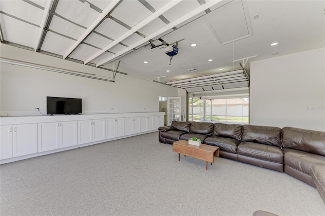 living area featuring recessed lighting, light carpet, and attic access
