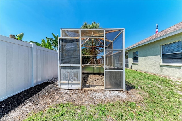 view of outbuilding featuring fence