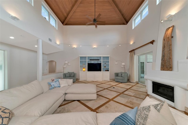 4307 Camino Real, Sarasota, FL 34231 - living area with wood ceiling, a fireplace, inlaid floor details, a high ceiling, and healthy amount of natural light