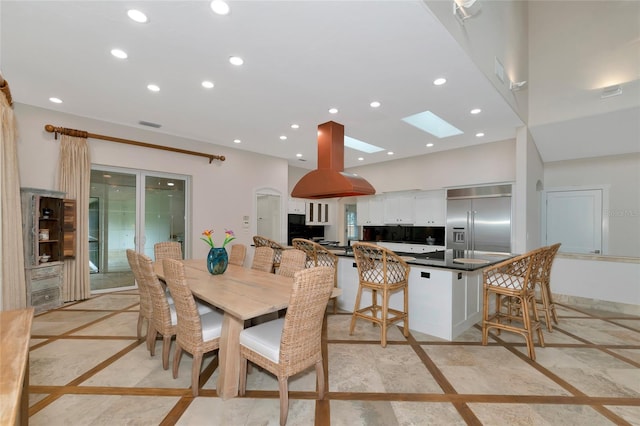 4307 Camino Real, Sarasota, FL 34231 - dining room with inlaid floor details, recessed lighting, and a skylight