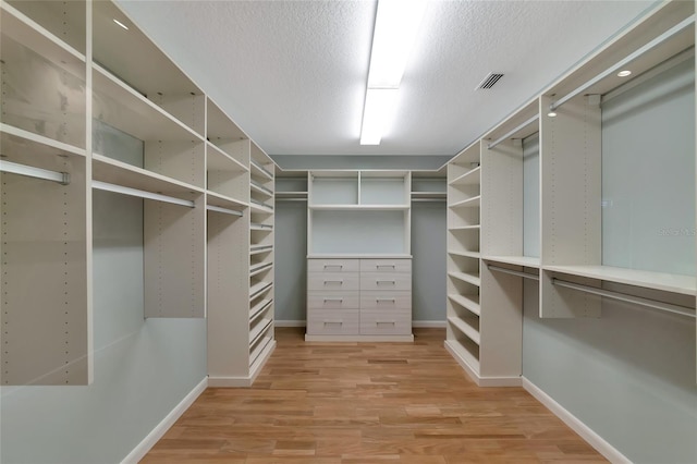 4307 Camino Real, Sarasota, FL 34231 - walk in closet featuring light wood-style floors