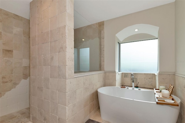 4307 Camino Real, Sarasota, FL 34231 - full bath featuring tile walls, a freestanding tub, and a wainscoted wall