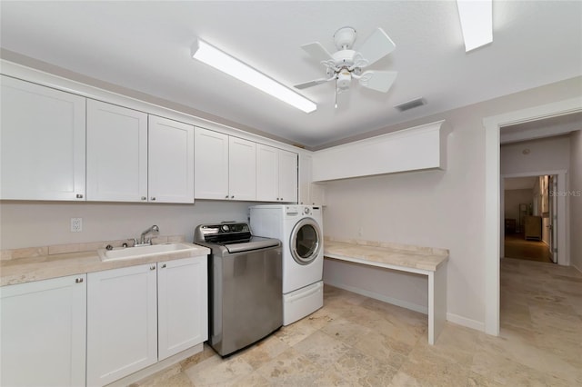 4307 Camino Real, Sarasota, FL 34231 - laundry area featuring separate washer and dryer, cabinet space, ceiling fan, and baseboards