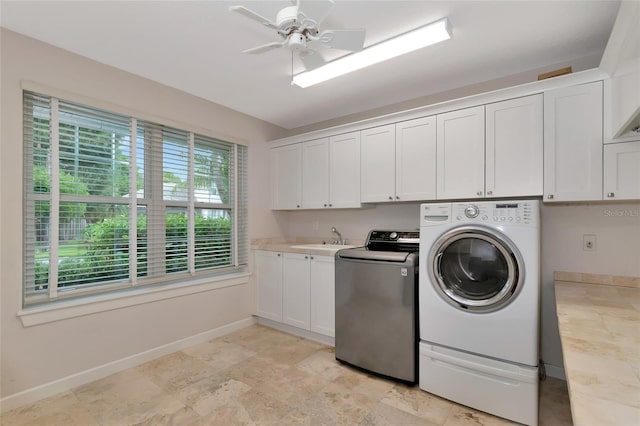 4307 Camino Real, Sarasota, FL 34231 - laundry area with separate washer and dryer, cabinet space, baseboards, and ceiling fan