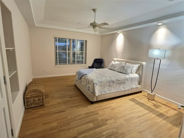4307 Camino Real, Sarasota, FL 34231 - bedroom featuring a raised ceiling, wood finished floors, baseboards, and a textured wall