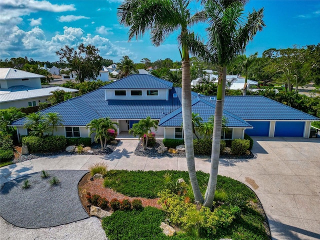 4307 Camino Real, Sarasota, FL 34231 - view of front facade featuring curved driveway, a tile roof, stucco siding, and a garage