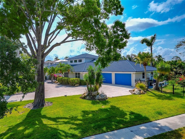 4307 Camino Real, Sarasota, FL 34231 - view of front of home featuring driveway, an attached garage, and a tile roof