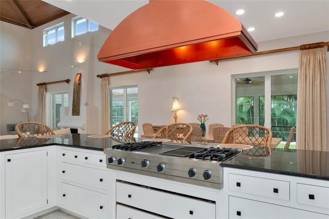 4307 Camino Real, Sarasota, FL 34231 - kitchen with dark countertops, exhaust hood, stainless steel gas cooktop, healthy amount of natural light, and recessed lighting