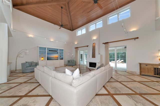 4307 Camino Real, Sarasota, FL 34231 - living area with inlaid floor details, a ceiling fan, wooden ceiling, and a towering ceiling