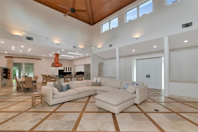 4307 Camino Real, Sarasota, FL 34231 - living room with inlaid floor details, a high ceiling, healthy amount of natural light, recessed lighting, and a ceiling fan