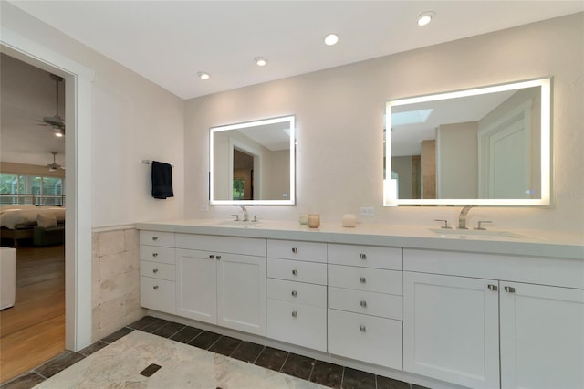4307 Camino Real, Sarasota, FL 34231 - bathroom with double vanity, ceiling fan, wood finished floors, wainscoting, and recessed lighting