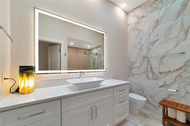4307 Camino Real, Sarasota, FL 34231 - bathroom featuring a stall shower, toilet, vanity, and marble finish floors