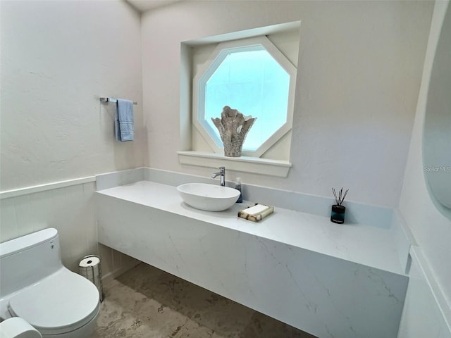 4307 Camino Real, Sarasota, FL 34231 - half bath featuring toilet, wainscoting, and vanity