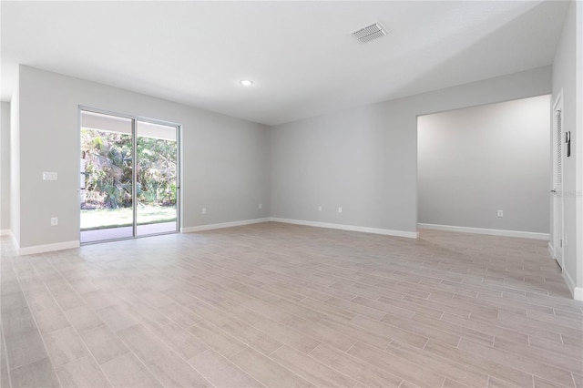 empty room with recessed lighting, baseboards, visible vents, and light wood-style floors