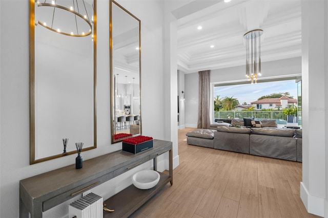 hall featuring radiator, wood finished floors, baseboards, recessed lighting, and a chandelier