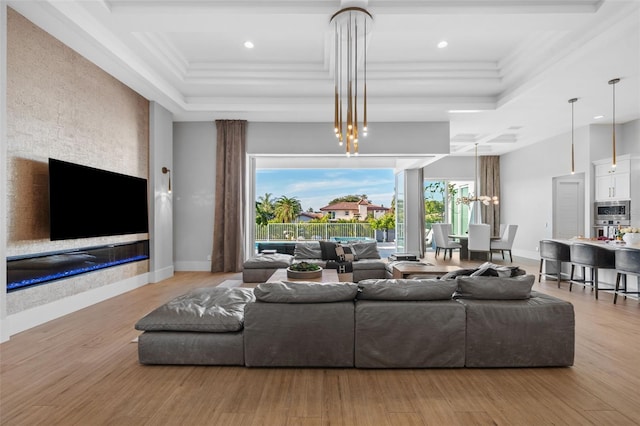 living area featuring recessed lighting, ornamental molding, coffered ceiling, and wood finished floors