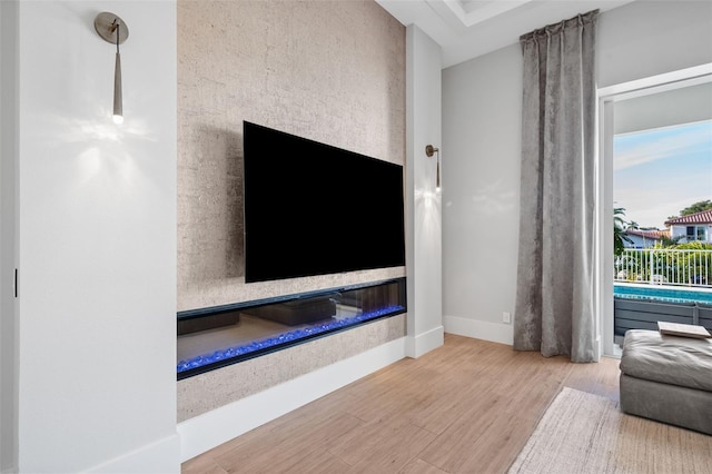 living area featuring baseboards and wood finished floors