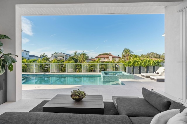 view of pool featuring outdoor lounge area, a patio area, fence, and a pool with connected hot tub