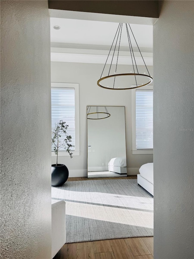 interior space with baseboards, a textured wall, and wood finished floors