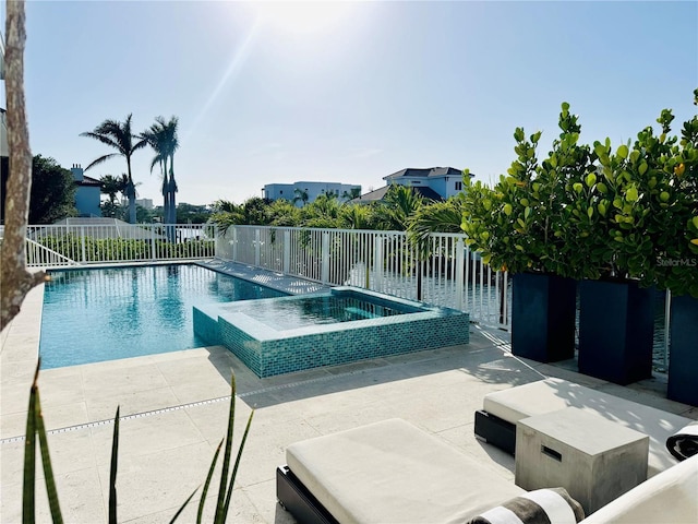 view of swimming pool featuring fence, an in ground hot tub, a fenced in pool, and a patio