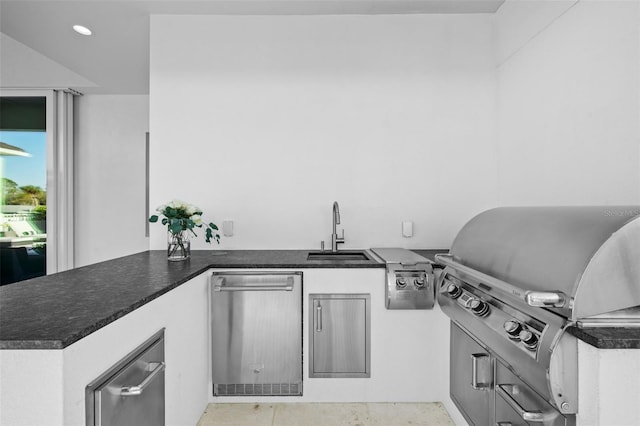 interior space with dark countertops, dishwasher, a sink, a peninsula, and recessed lighting