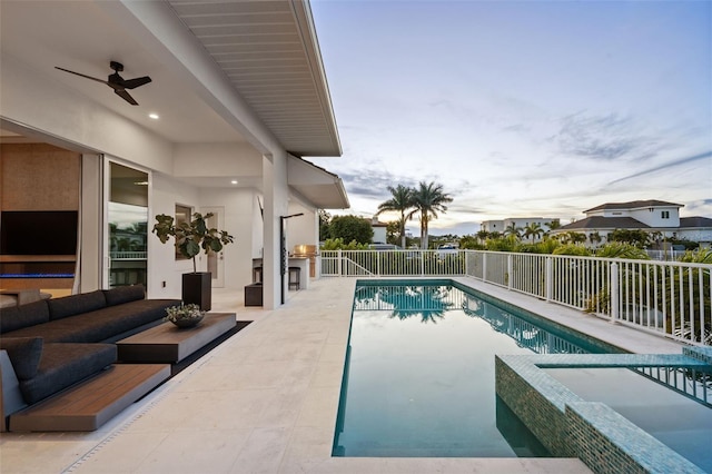 view of swimming pool with ceiling fan, outdoor lounge area, fence, a patio, and a pool with connected hot tub
